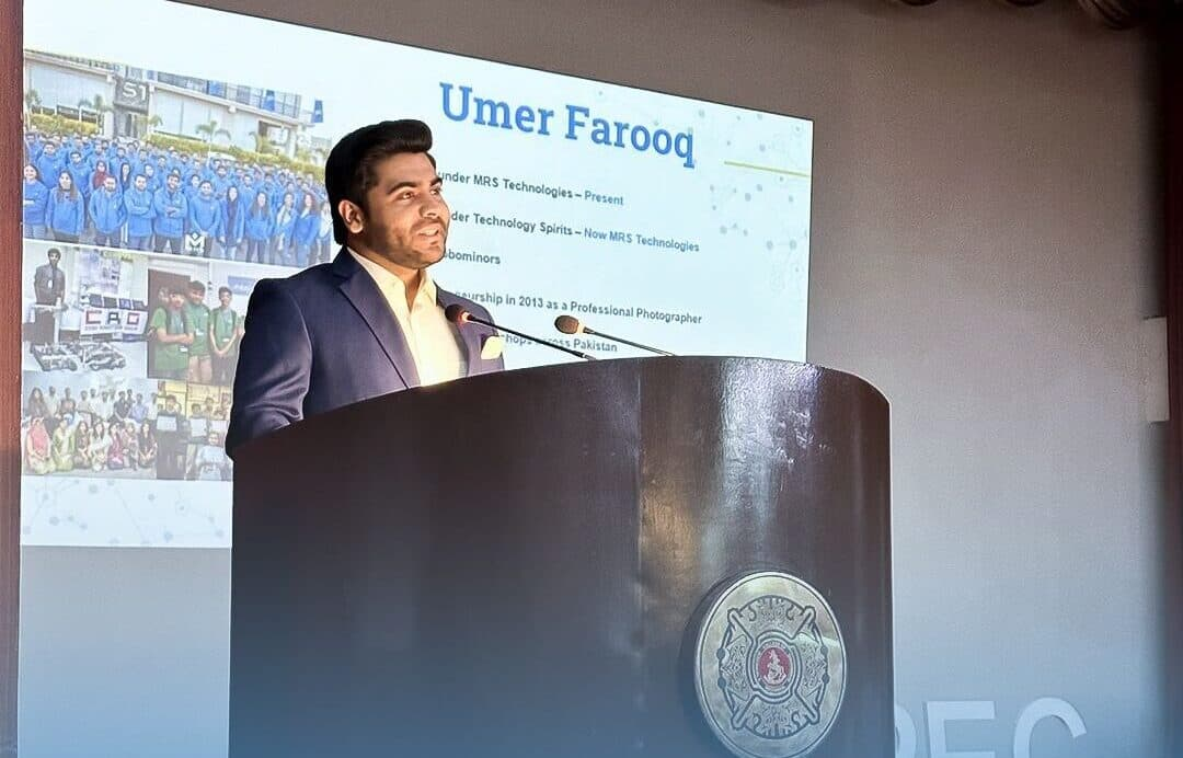 Umer Farooq speaking at a podium